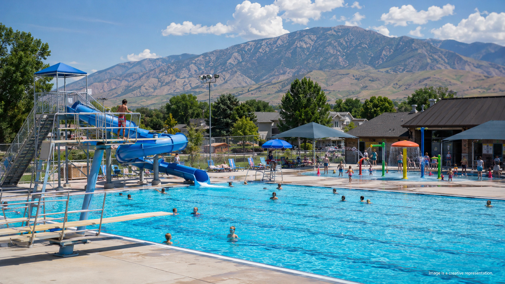 Nephi City Pool with blue waterslide, splash pad, and Mount Nebo in the background