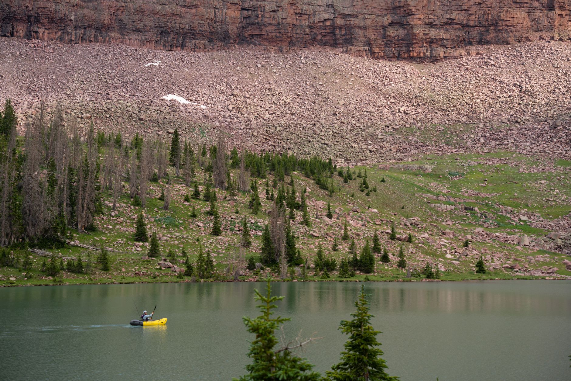 A kayaker on a calm alpine lake at Payson Lakes