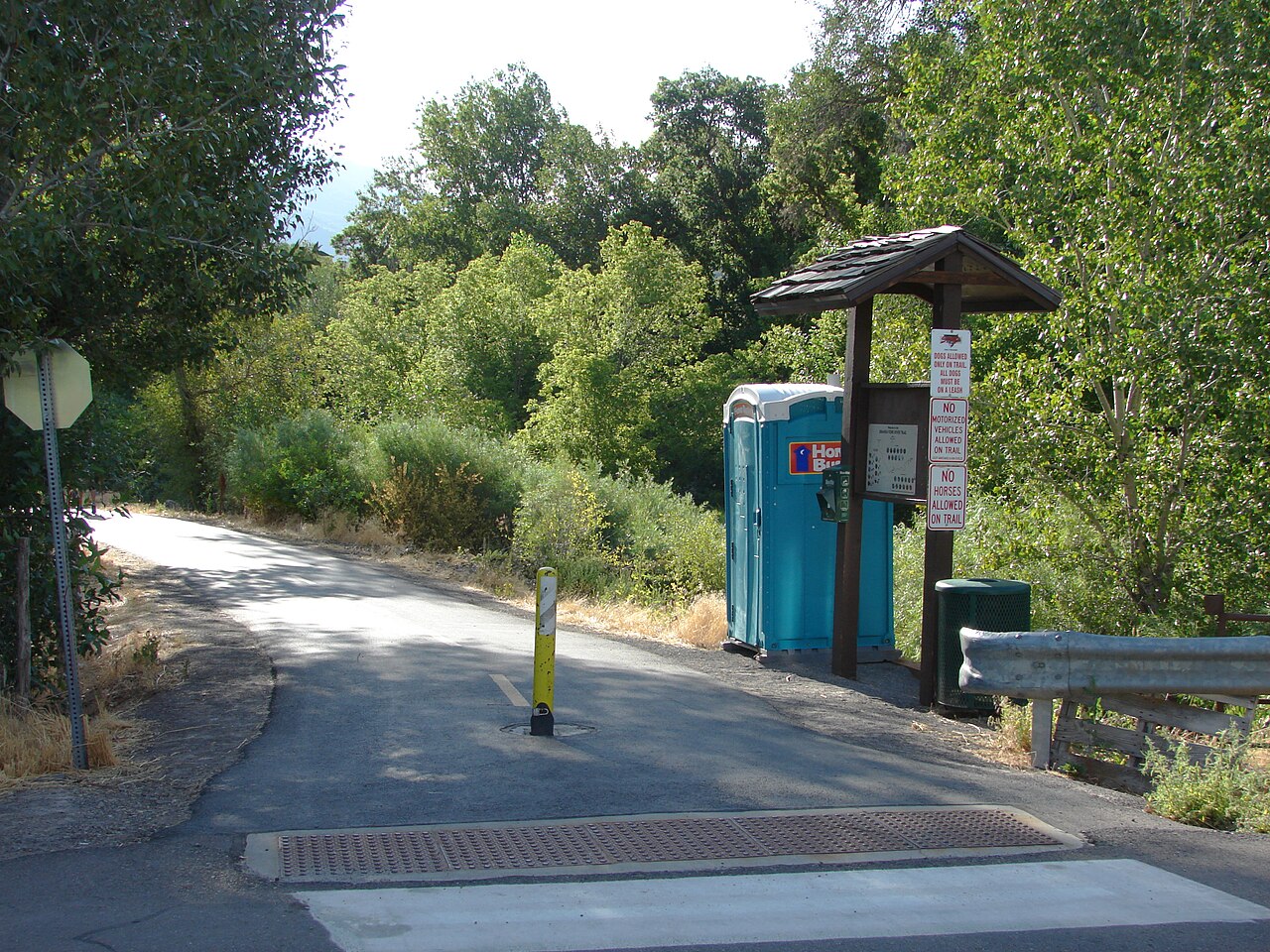 Spanish Fork River Trail heading east from 1100 East — paved path, kiosk, and trees