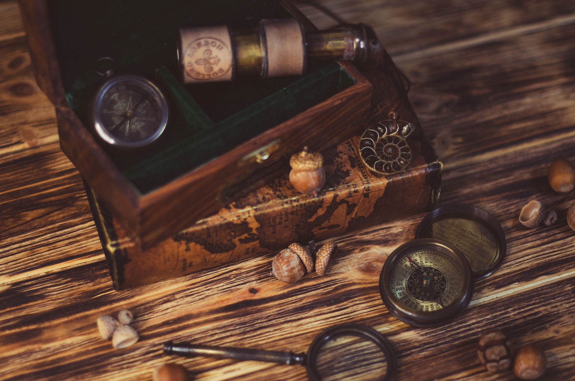 An assortment of vintage knickknacks and small antiques on a wooden surface